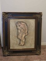 Front view of framed mixed-media relief artwork