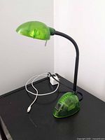 Full view of green desk lamp on surface