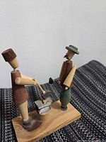 Full view of wooden blacksmith scene on base