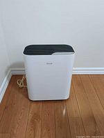 Front view of Levoit air purifier showing white body and power cord