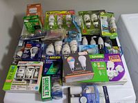 Pile of packaged light bulbs various brands and types