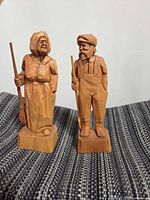 Front view of both wooden figurines
