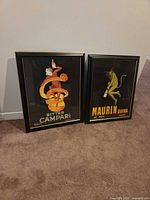 Both framed prints standing side by side