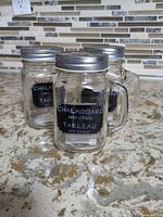 All three glass mason jar mugs shown with lids attached