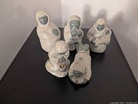 Group shot of five soapstone Inuit figurines