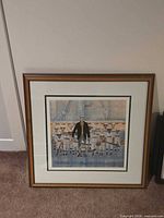 Full view of framed lithograph leaning against wall