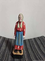 front view of carved wooden woman figurine