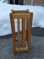Front view of square slatted light oak umbrella stand