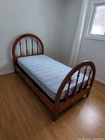 Twin bed frame with mattress and box spring, side angle