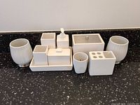 Group shot of entire white ceramic bathroom accessory set