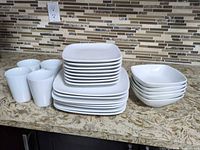 Group shot of entire dinnerware set showing plates, bowls, mugs
