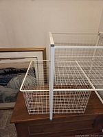 Side view showing basket nested inside square wire frame