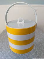 Ice bucket front view with lid and handle upright