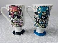 Front view of both mugs showing designs and bases