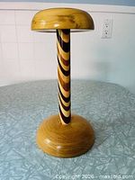 Full view of wood hat stand showing shape and laminated stem