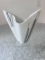 Front three-quarter view of vase showing shape and black linear design