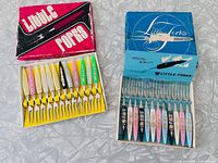 Both boxes opened showing 24 little forks with coloured handles