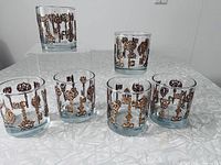 Front view of all six glasses displaying gold skeleton key pattern