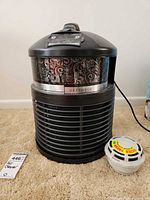 Front view of FilterQueen Defender purifier with filter cartridge