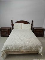 Front view of assembled queen bed showing wooden headboard and metal frame on casters