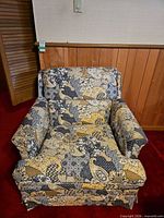 Front angled view of patterned upholstered armchair