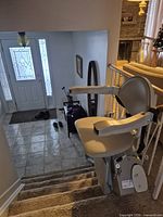 Chair lift seat mounted on stair rail