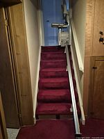 Front view of staircase showing full length of rail and carriage