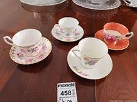 Overview of four teacup and saucer sets showing patterns and colours
