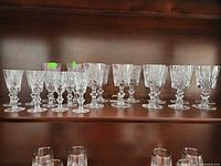Front view of all 20 crystal glasses on shelf