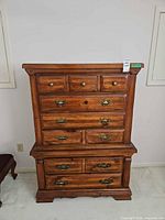 Front view of wood dresser showing all drawers and hardware