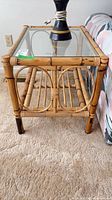 front view of bamboo and rattan end table with glass top