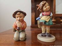 Both Goebel Hummel figurines, boy and girl