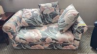 Front view of upholstered floral loveseat with cushions