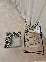 Magazine rack and basket side by side on floor