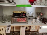 Shelf view showing Regal Ware bowl, silver-plate holder with glass dish, glass bowl with handle, round silver-plate dish, pair silver goblets