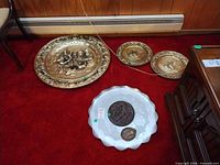 All items laid out: three brass chargers, aluminum tray, two plaques