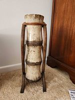 Front view of ceramic umbrella stand in metal frame