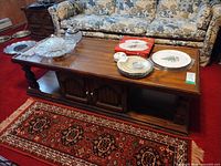 Full view of coffee table with storage doors, items on top not included
