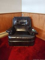 Front view of black faux leather recliner showing overall design