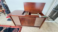 Full view of Philips walnut stereo console with lid open showing turntable compartment