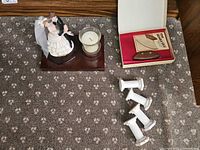 Overview of figurine, boxed ULU set, and four cutter rests