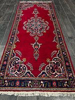 Full view of the Persian runner showing design, colors, fringe