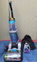 Full view of carpet cleaner, formula bottle and hose bag