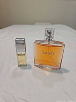 Front view of both perfume bottles showing labeling and size comparison