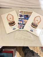 Three magazines laid out: Yearbook centre, two identical trophy-cover issues left and right