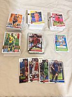 Overall view of multiple stacks of soccer trading cards, showing variety and quantity
