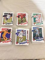 Six visible stacks of Panini Donruss 2021-22 soccer base cards on surface