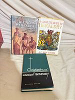 All three hardcover books standing and lying to show covers