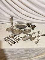 Group shot of all silver-tone items on cloth backdrop