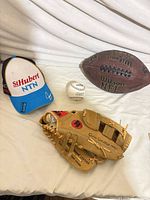 Group shot with glove, football, cap, baseball